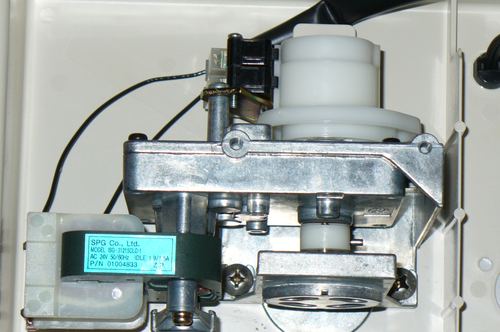Close-up of a water softener control valve motor assembly