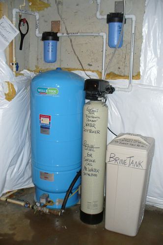Pressure tank, EcoSoft 32K water softener with brine tank, and well pump installed together