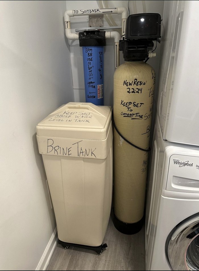 Water softener and brine tank installed in a tight laundry closet in a newer Ranson, WV home on municipal water